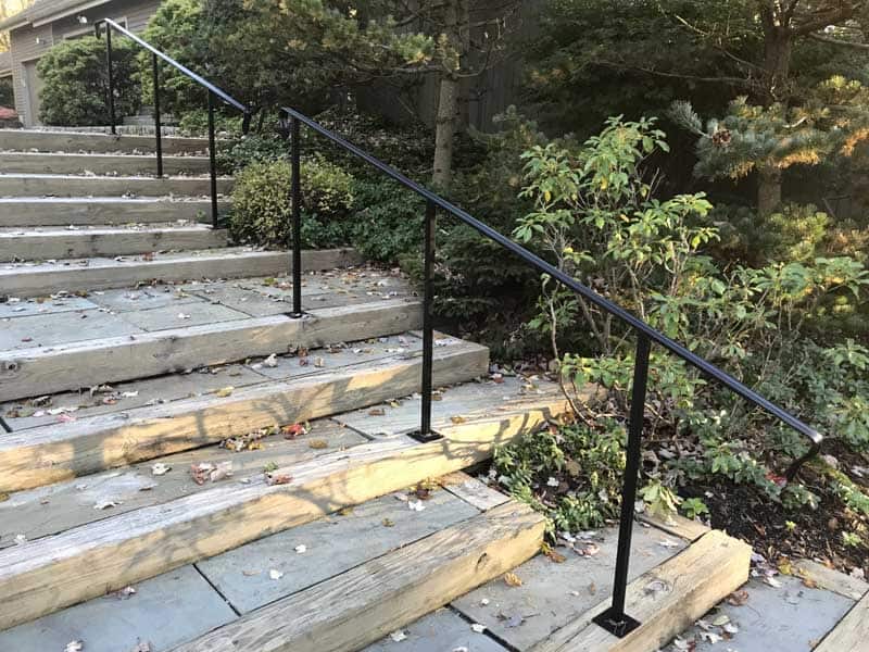 Shovel in front of a wall of at least4 feet of snow on a roof.