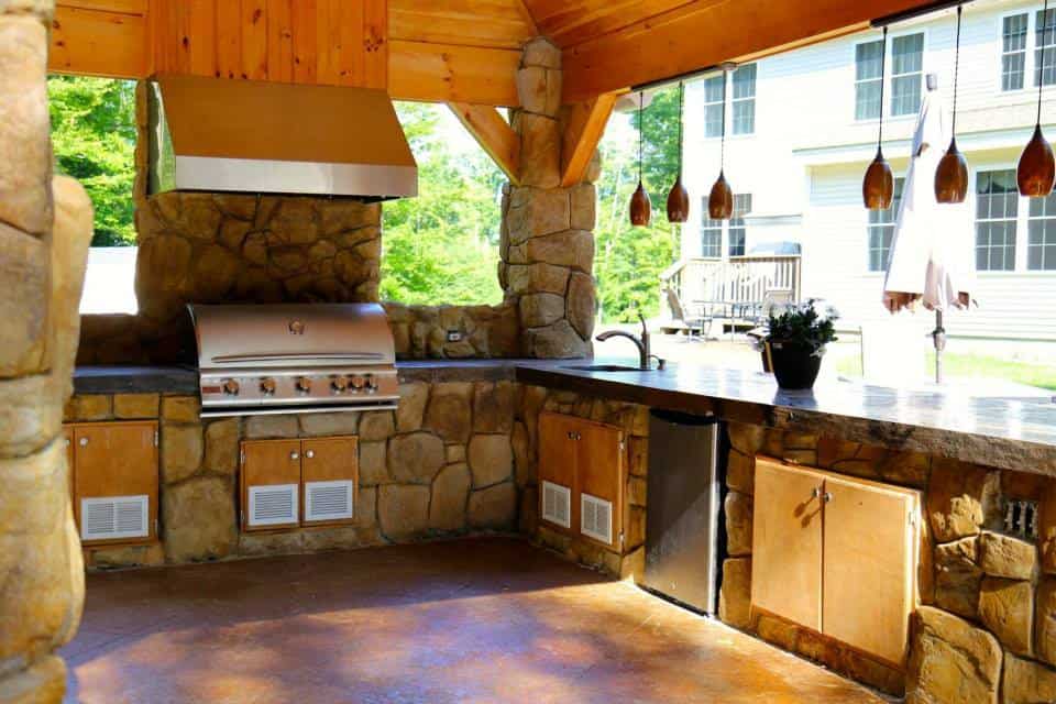 Outdoor kitchen with pendant lights.